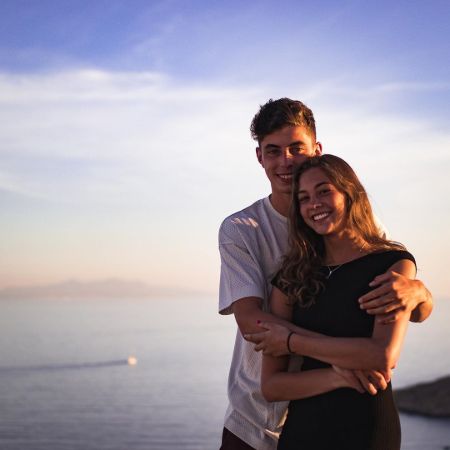 Kai Havertz in a white t-shirt hugging his girlfriend Sophie Weber.